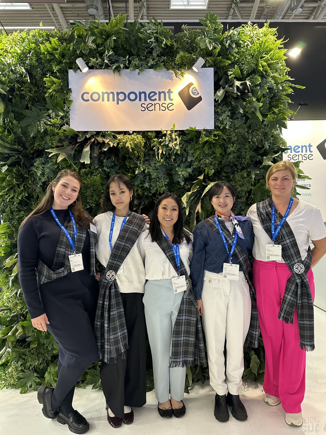 Five members of the Component Sense team standing in front of the Component Sense stand
